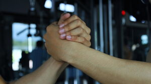 Close-up of two athletes clasping hands