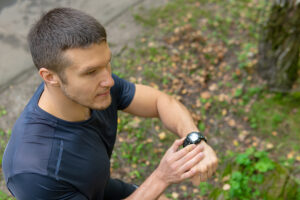 Male athlete adjusting his watch