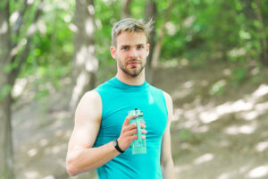 Male athlete holding water bottle