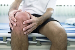 Male athlete with knee pain caused by tendinopathy