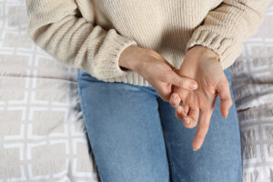 Woman touching her painful trigger finger